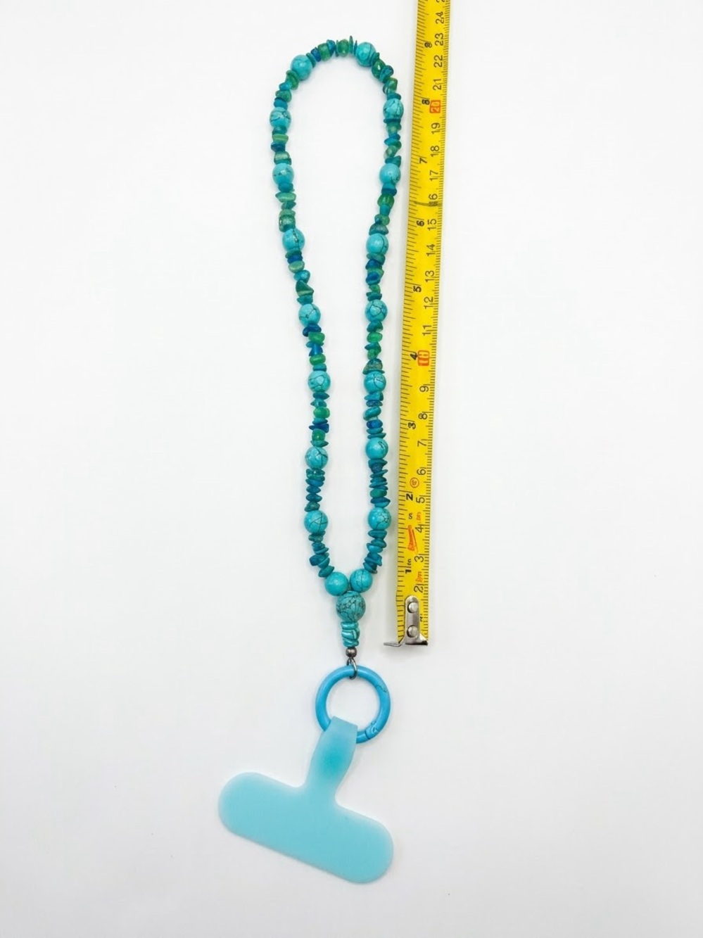 Turquoise beaded phone charm.